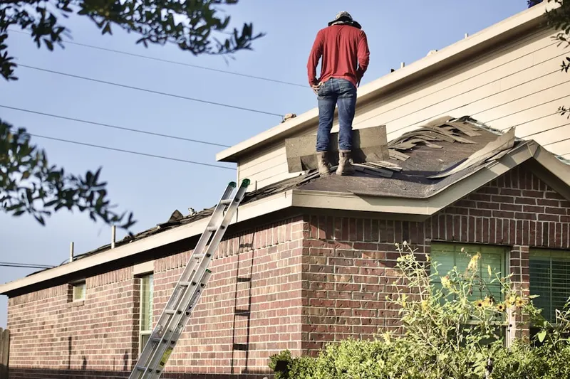 Professional roofer working on a residential roof in West Carteret